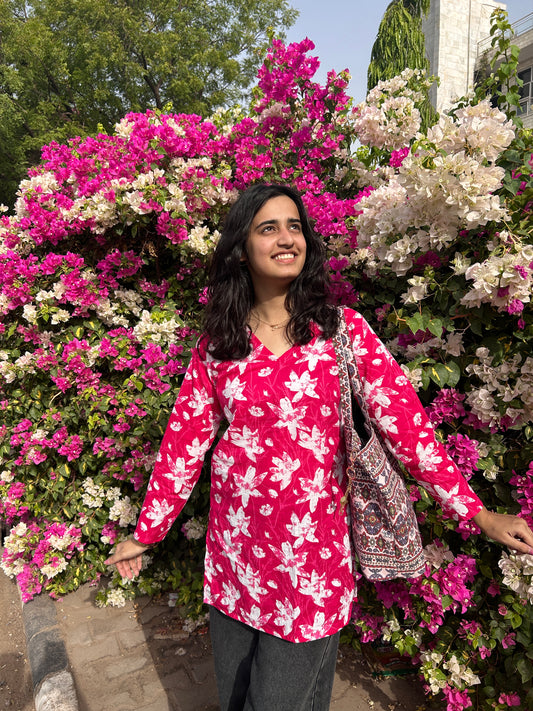 Relaxed fit pink printed cotton kurta styled with black jeans and sling bag