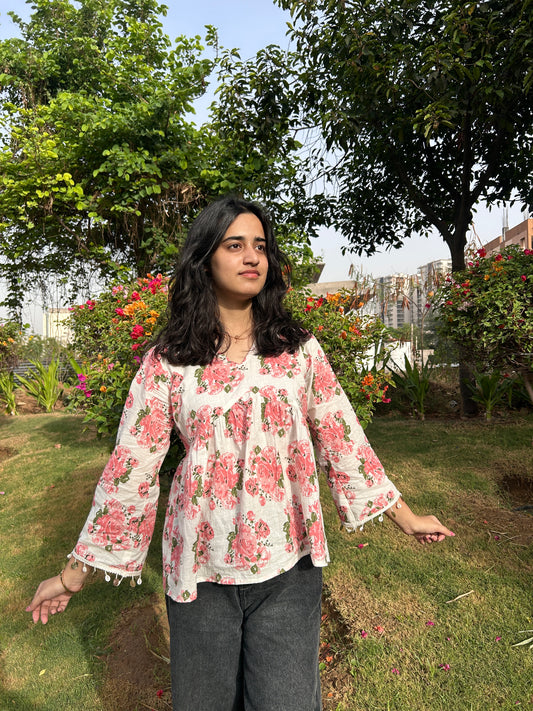 Front view of soft blush rose print kurti with gathered yoke and lace sleeve detail”